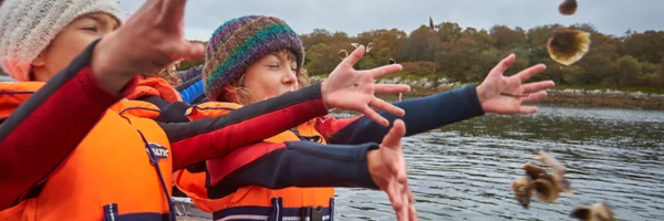 Throwing oysters off of a boat