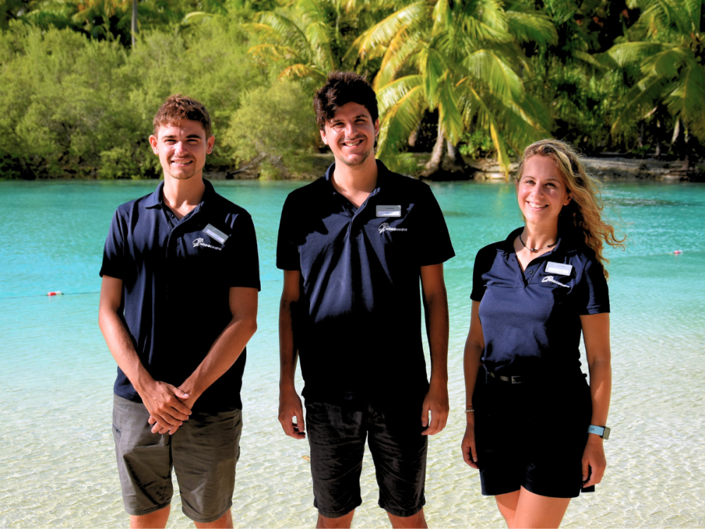 Three WiseOceans Marine Biologists standing on a beach on the edge of a lagoon